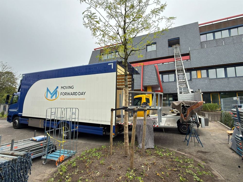 Moving Forward Day removal truck and an outside lift set up at an office building